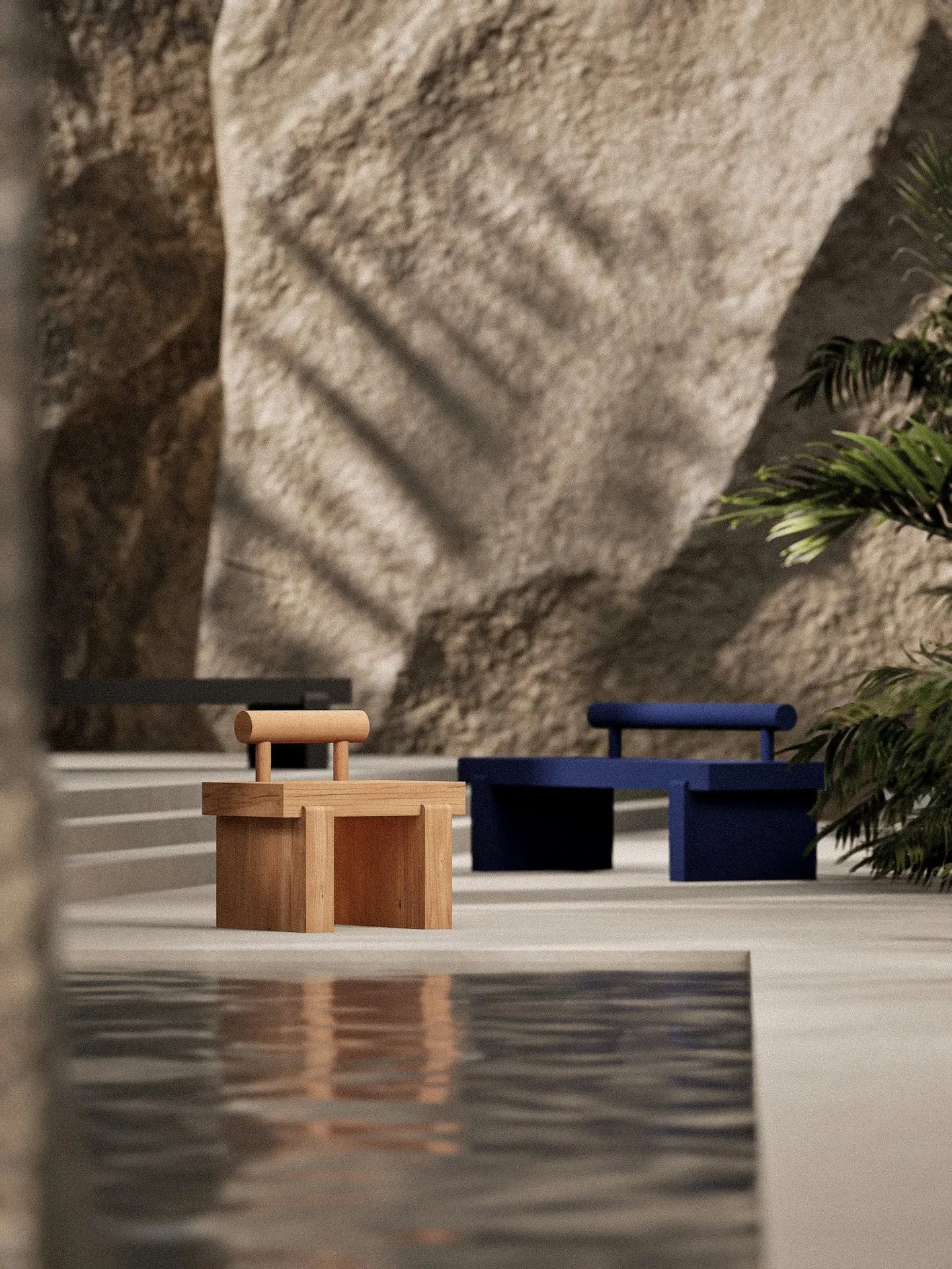 Totem benches in oak and blue beside a rock wall and a reflecting pool